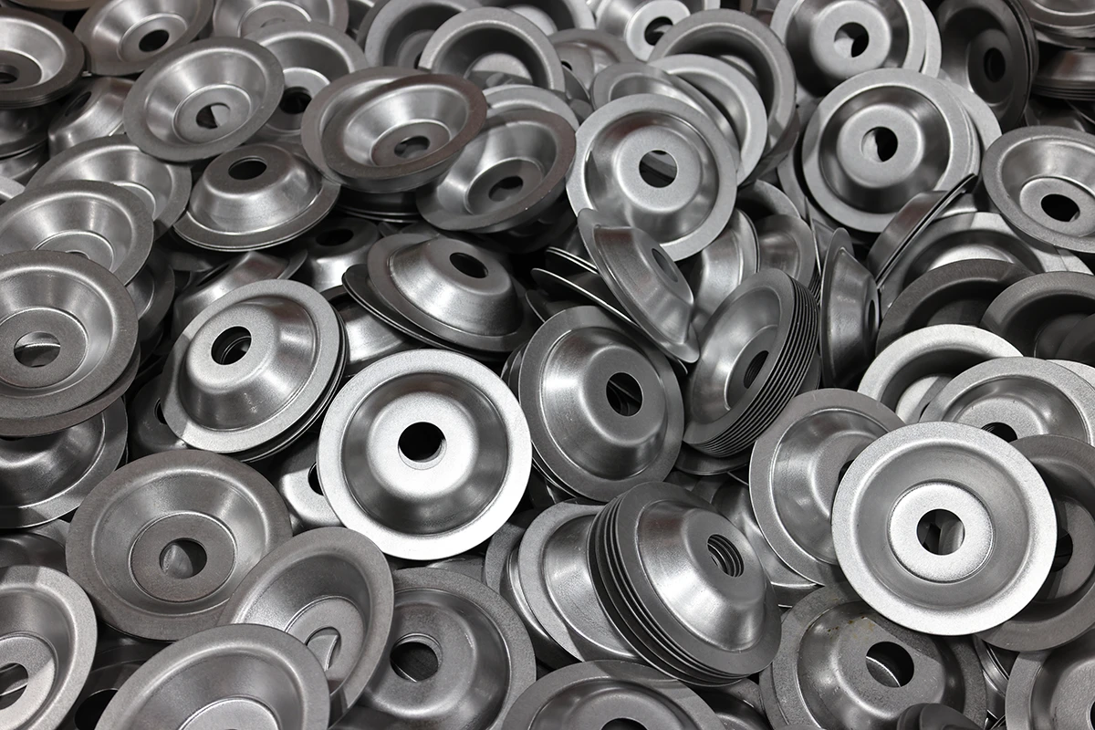 Deep drawn metal cups and washer components for precision applications