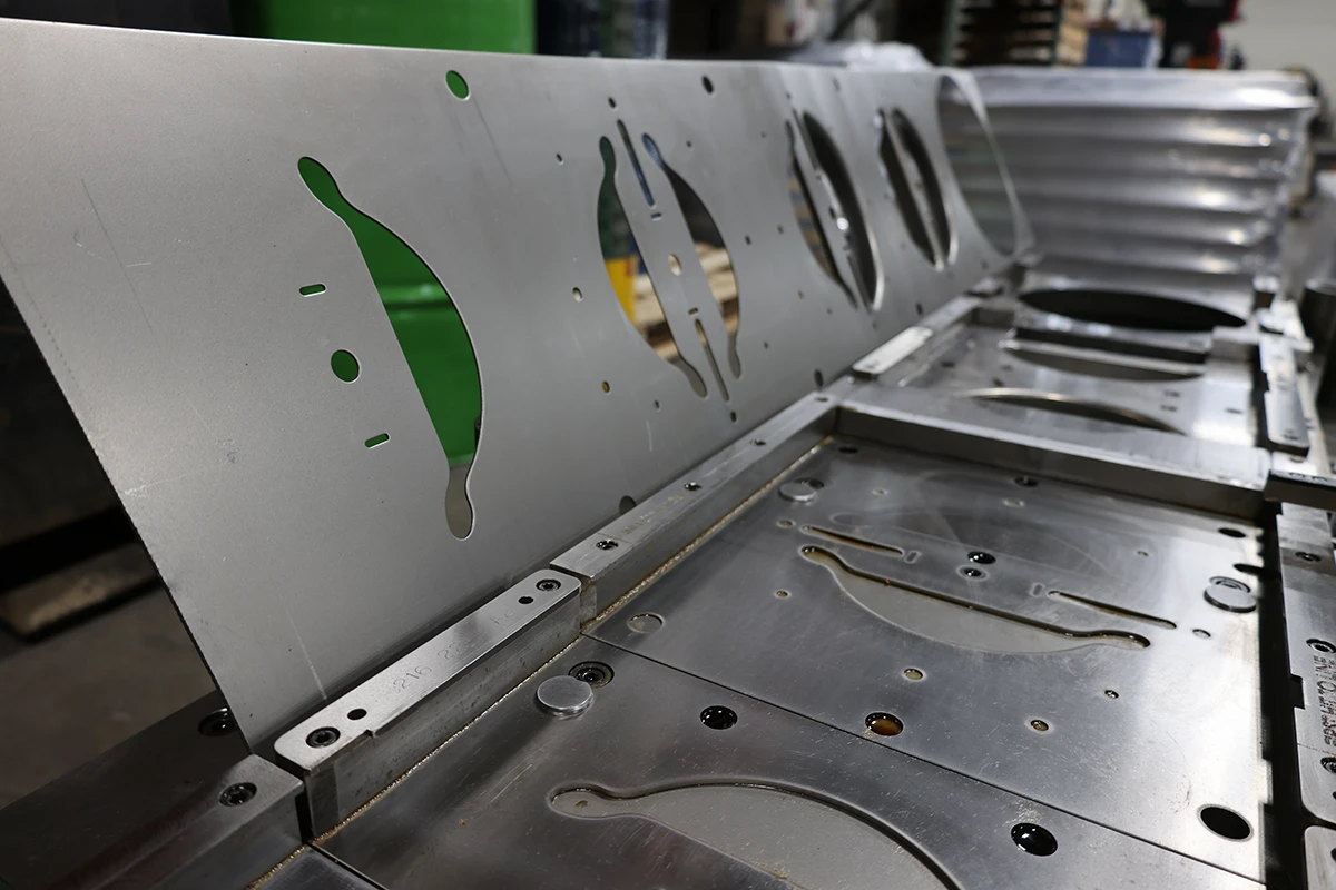 Formed sheet metal panel with cutouts for energy and power fabrication support