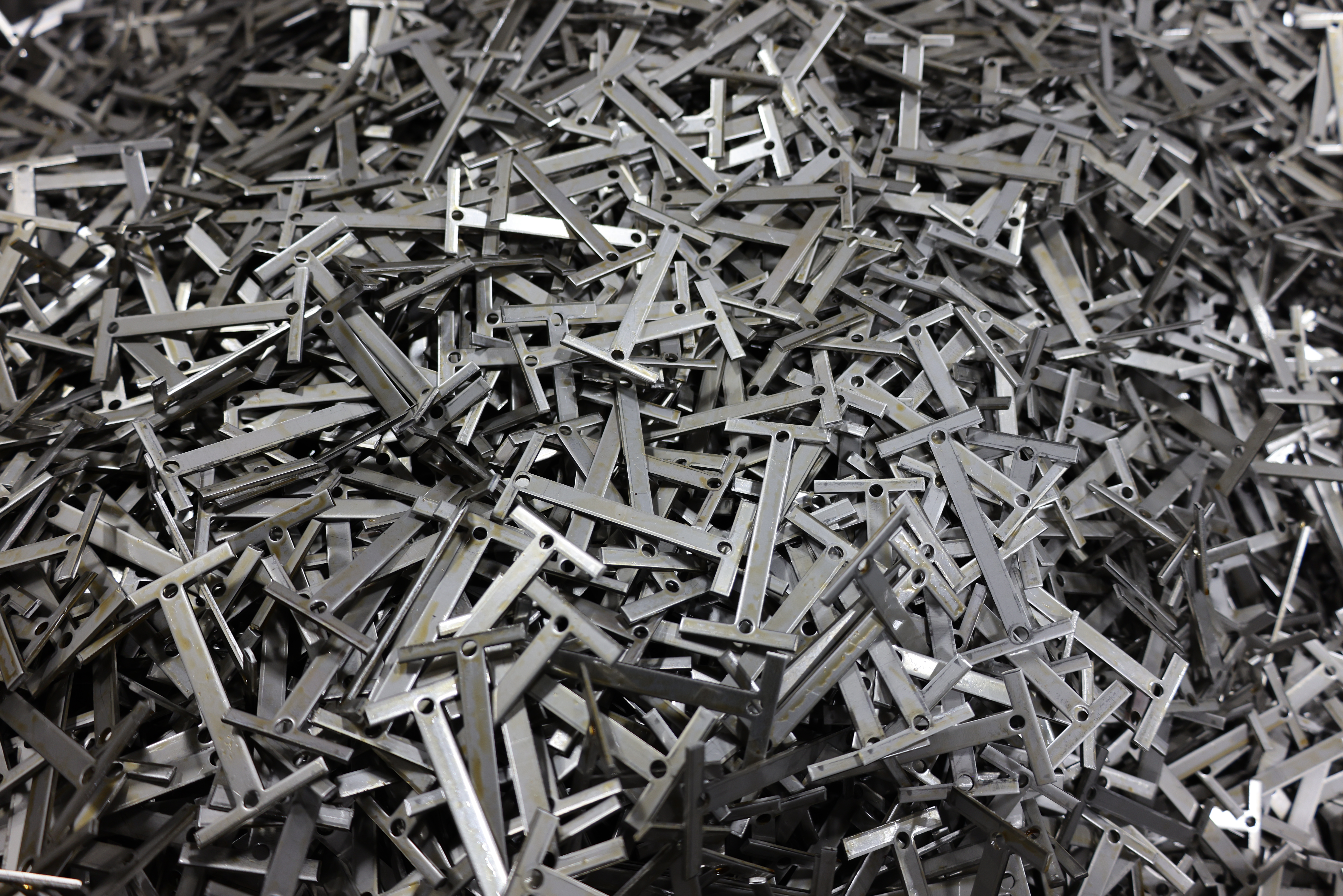 Finished stamped metal brackets batch for electronics and technology applications